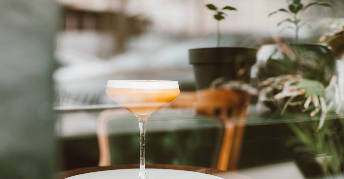 A cocktail on an outdoor bar at golden hour